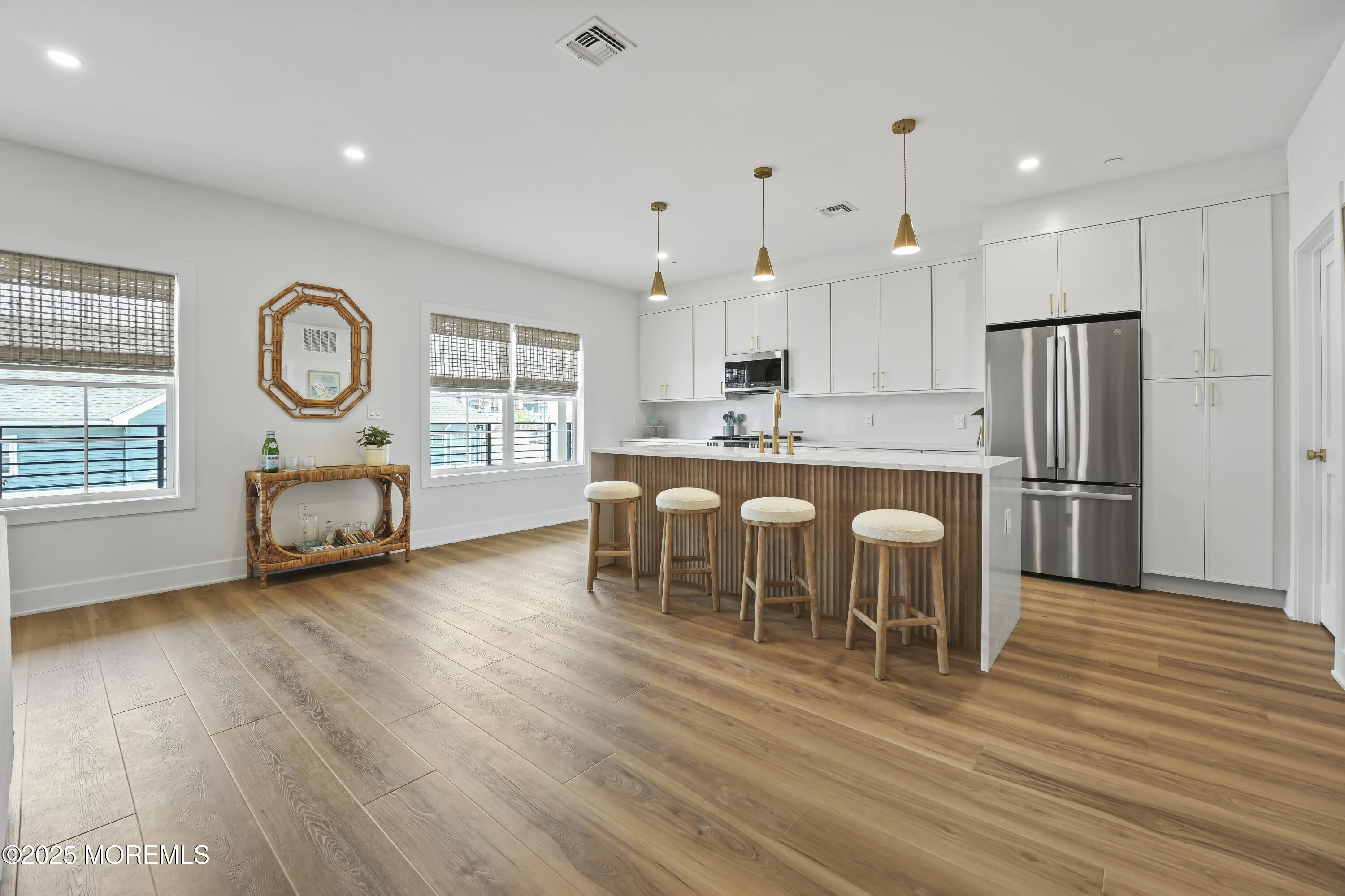 33 Hamilton Avenue, Unit 2 Seaside Heights, NJ 08751 - Photo 6 of 32 a kitchen with stainless steel appliances granite countertop a refrigerator a stove a sink a dining table and chairs with wooden floor