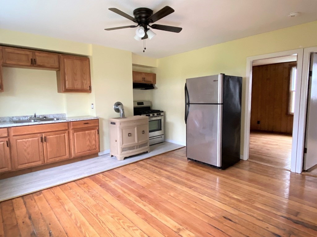 482 Snell Street Fall River, MA 02721 - Photo 12 of 41 a kitchen with stainless steel appliances a refrigerator sink and cabinets