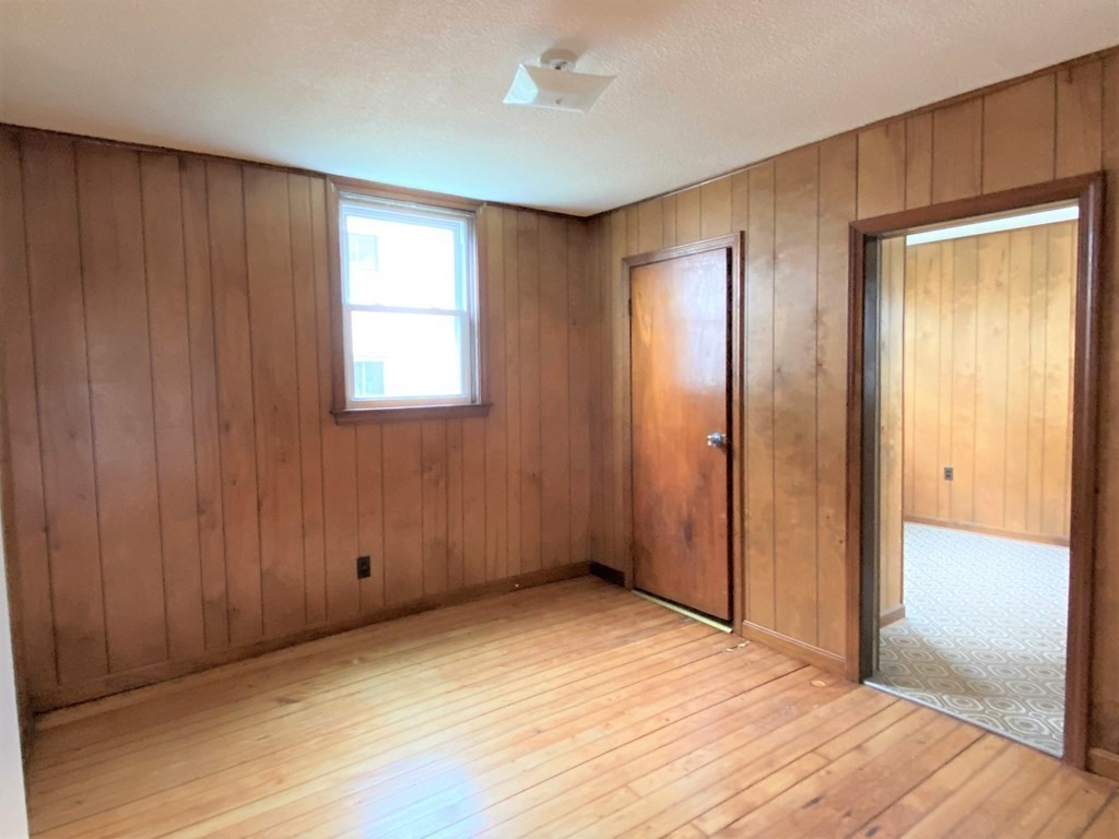 482 Snell Street Fall River, MA 02721 - Photo 16 of 41 an empty room with closet and windows