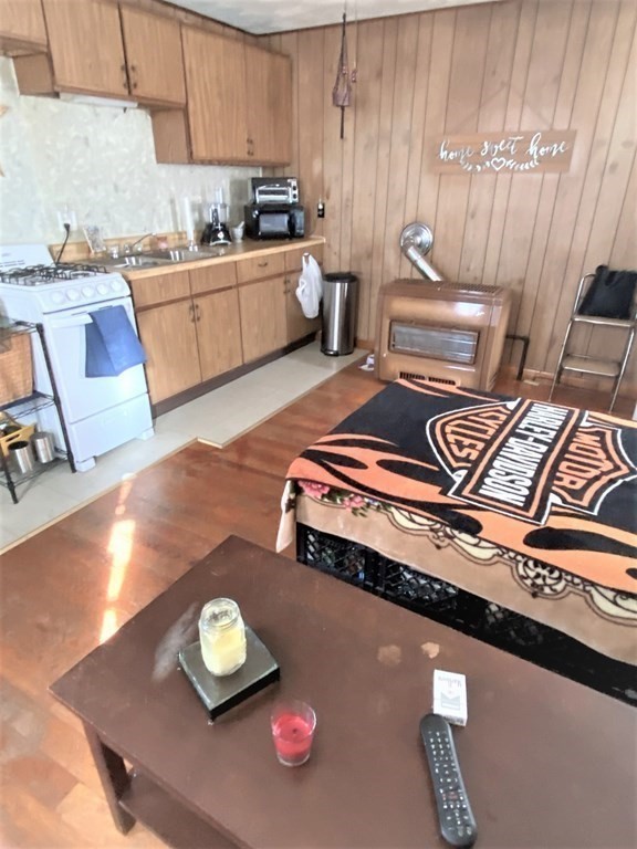 482 Snell Street Fall River, MA 02721 - Photo 20 of 41 a kitchen with a stove a sink and a microwave