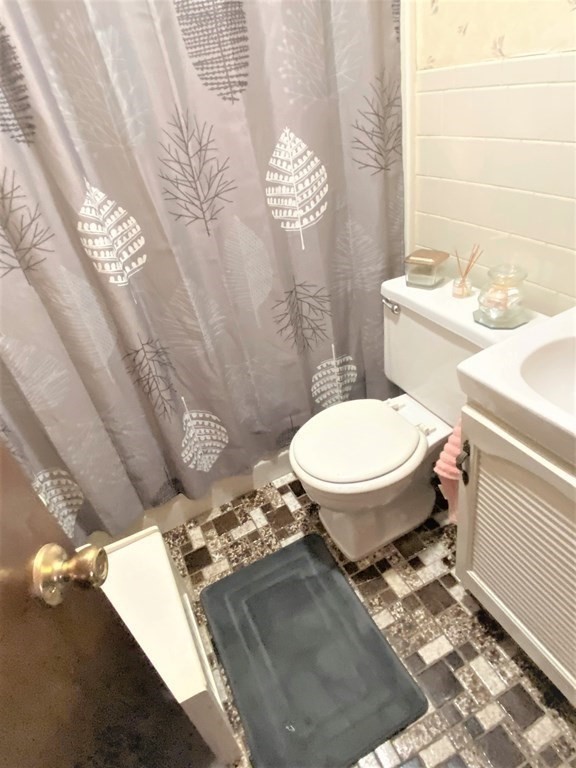 482 Snell Street Fall River, MA 02721 - Photo 23 of 41 a bathroom with a sink toilet and a mirror