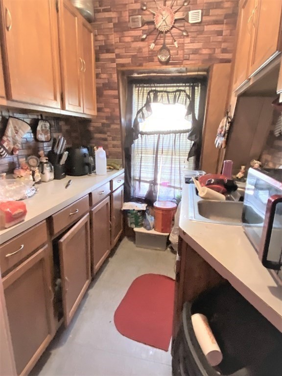 482 Snell Street Fall River, MA 02721 - Photo 26 of 41 a kitchen with a sink stove and cabinets