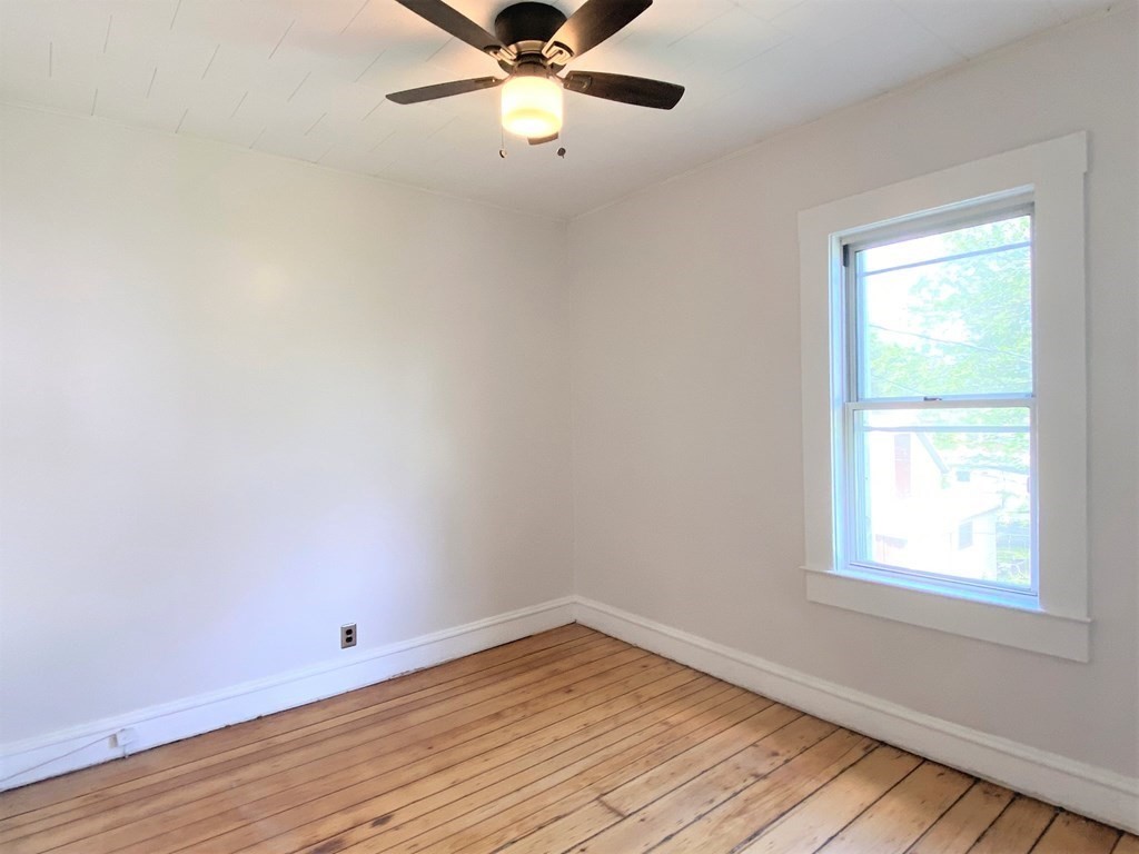 482 Snell Street Fall River, MA 02721 - Photo 6 of 41 wooden floor in an empty room with a window