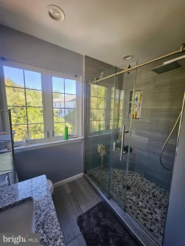 a spacious bathroom with a double vanity sink a mirror and a bathtub
