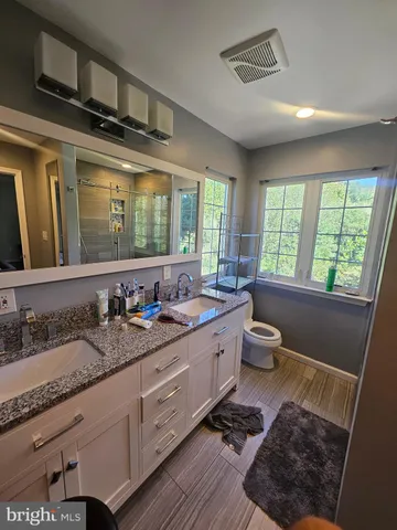 a bedroom with furniture and a wooden floor