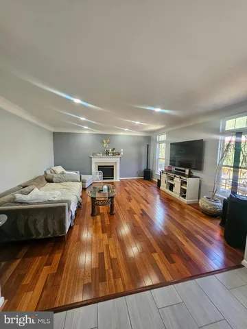 a bedroom with a bed and a flat tv screen on a dresser