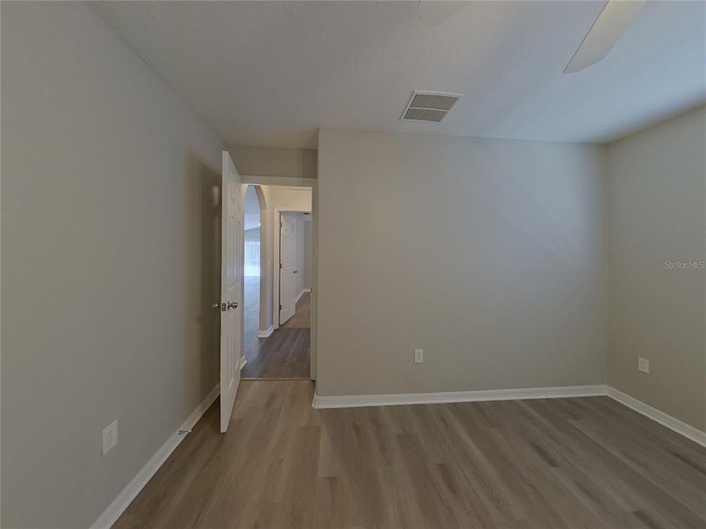 Undisclosed Address Wesley Chapel, FL 33545 - Photo 11 of 17 a view of an empty room with wooden floor and a window