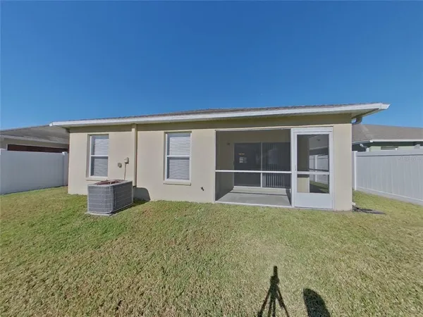 a view of a house with backyard and a garden
