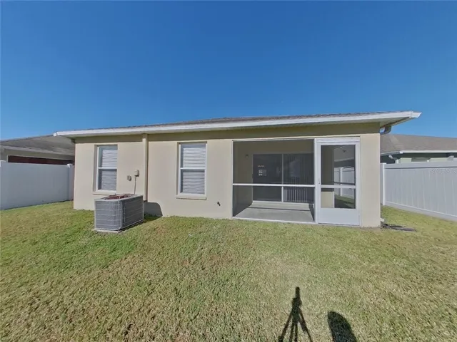 a view of a house with backyard and a garden