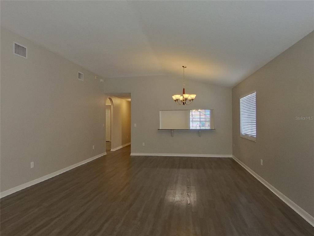 Undisclosed Address Wesley Chapel, FL 33545 - Photo 3 of 17 an empty room with wooden floor and windows
