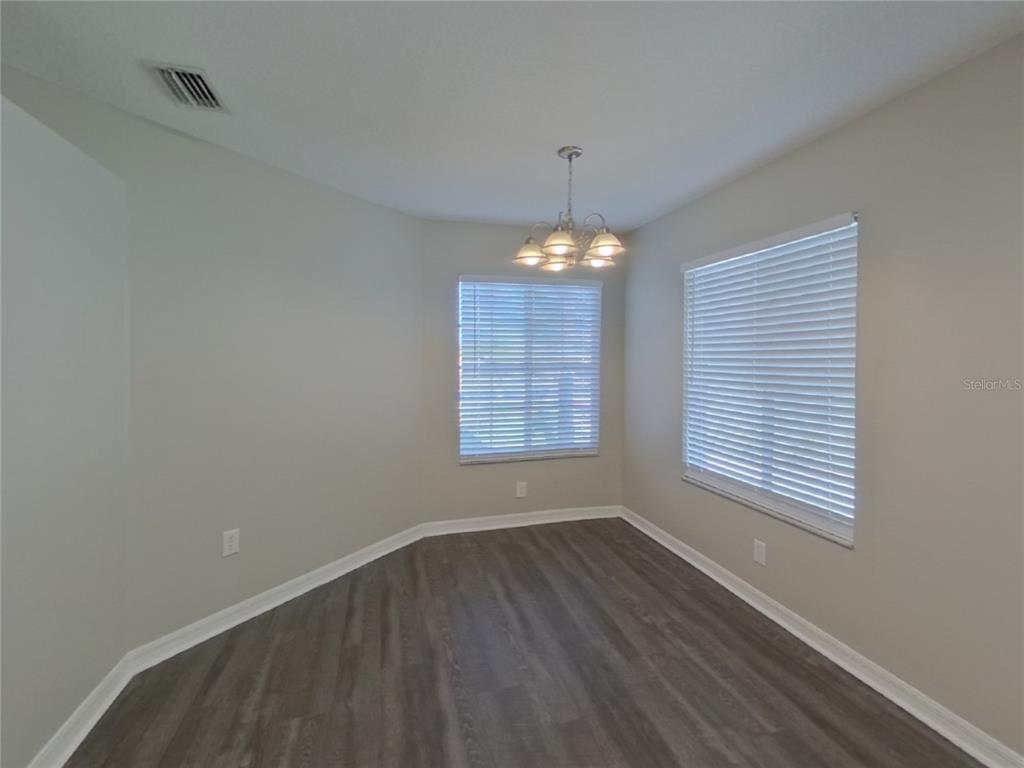 Undisclosed Address Wesley Chapel, FL 33545 - Photo 4 of 17 a view of an empty room with window and chandelier fan
