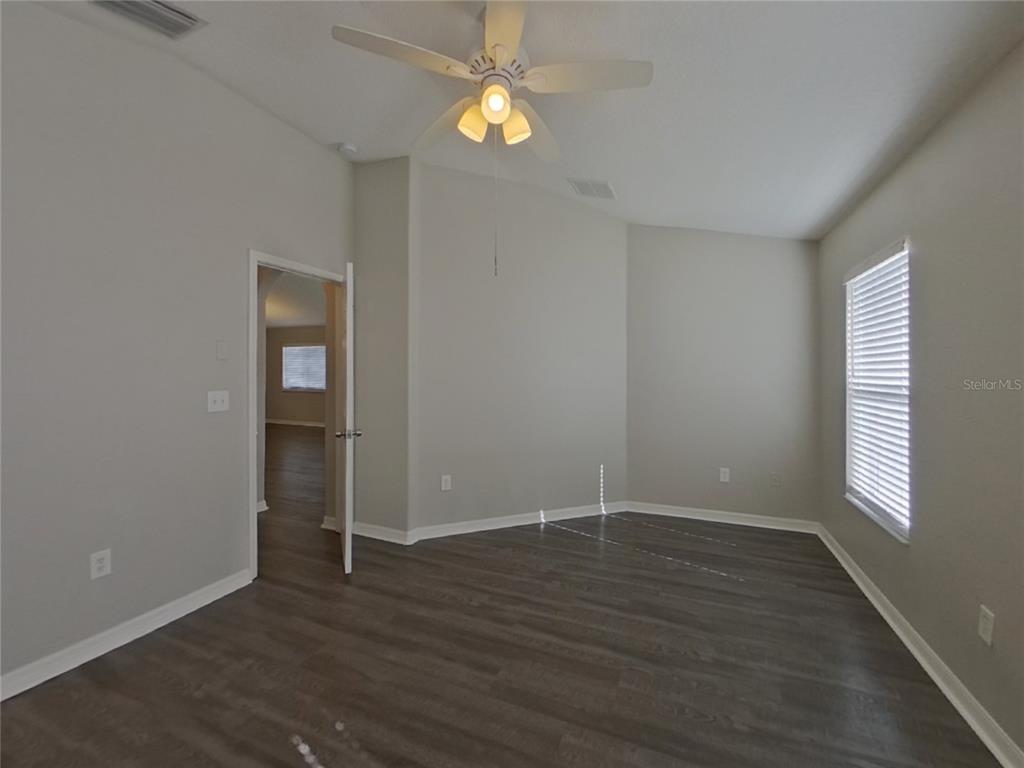 Undisclosed Address Wesley Chapel, FL 33545 - Photo 7 of 17 wooden floor in an empty room with a window
