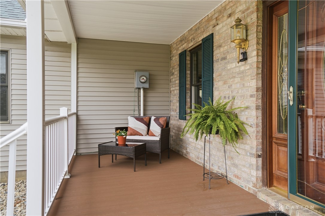 7553 Coffin Station Road Springfield, OH 45502 - Photo 13 of 95 This inviting covered porch features classic brickwork and a warm wooden entrance.