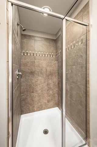 a bathroom with a glass shower door