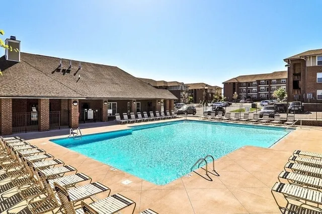 a front view of a house with a yard and glass windows