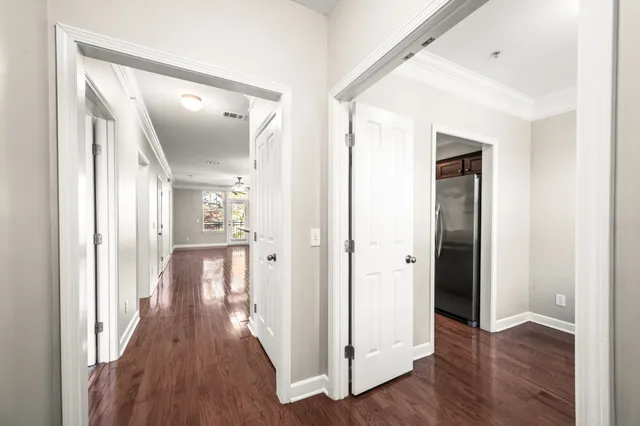 a view of a hallway with wooden floor