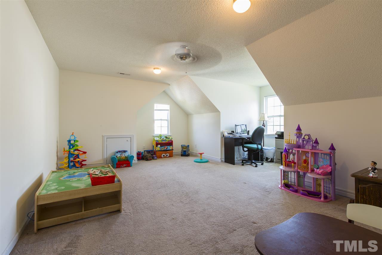 5302 Interlock Drive Raleigh, NC 27610 - Photo 19 of 19 a living room with furniture and a flat screen tv