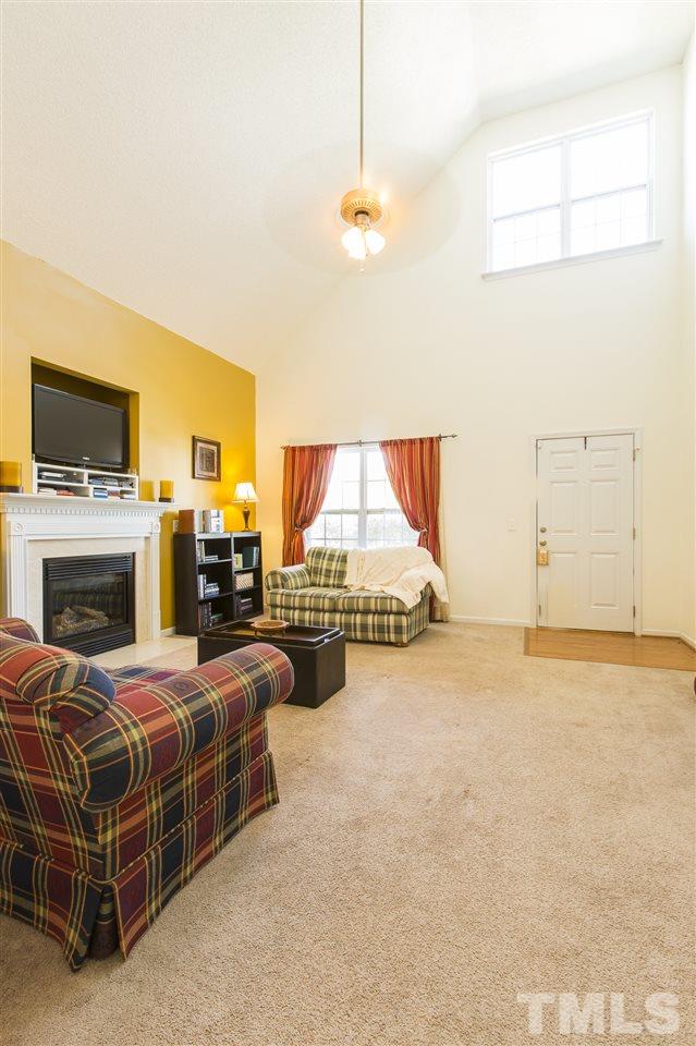 5302 Interlock Drive Raleigh, NC 27610 - Photo 5 of 19 a bedroom with a bed flat screen tv and a fireplace