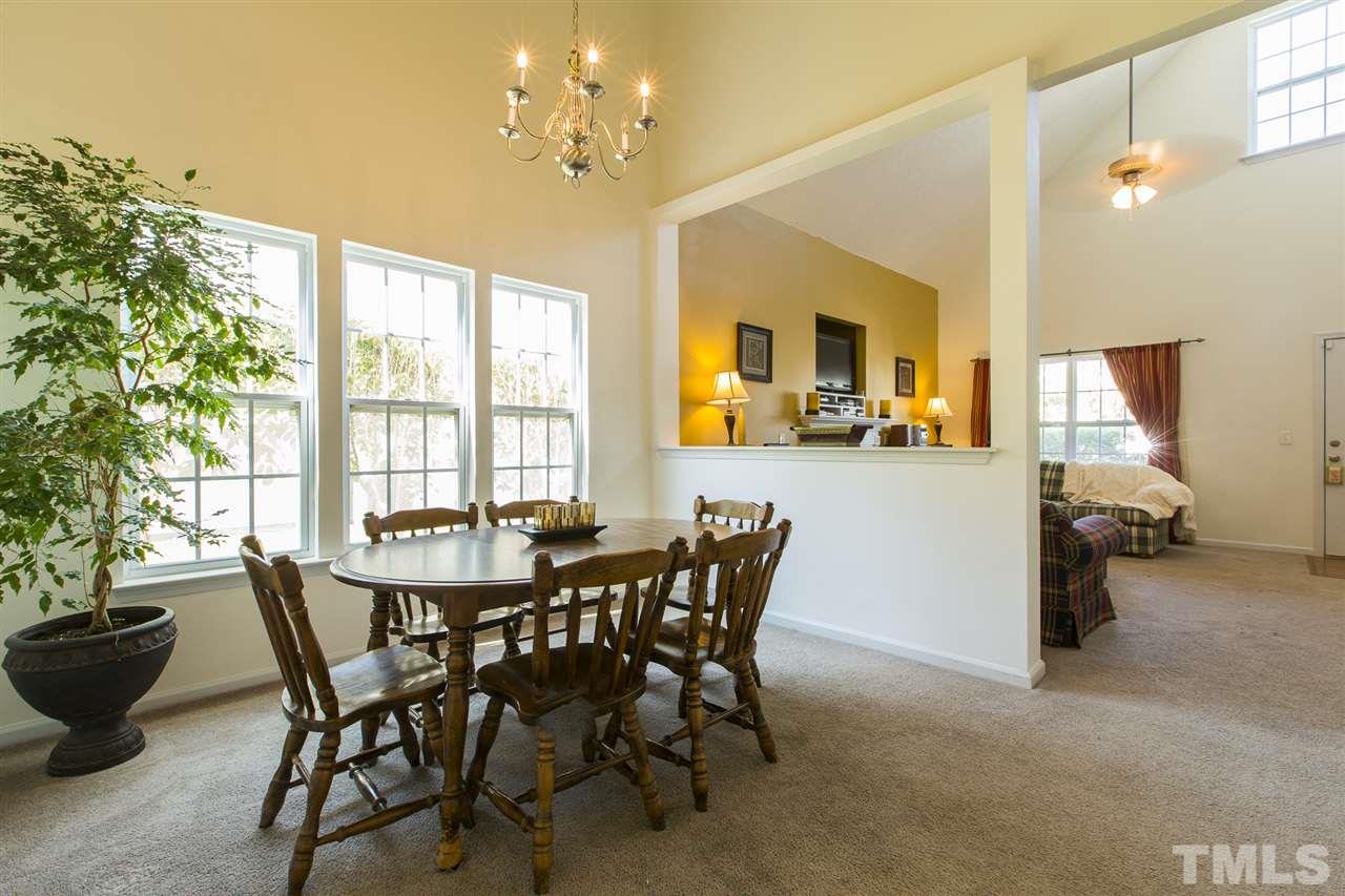5302 Interlock Drive Raleigh, NC 27610 - Photo 6 of 19 a view of a dining room with furniture and a chandelier