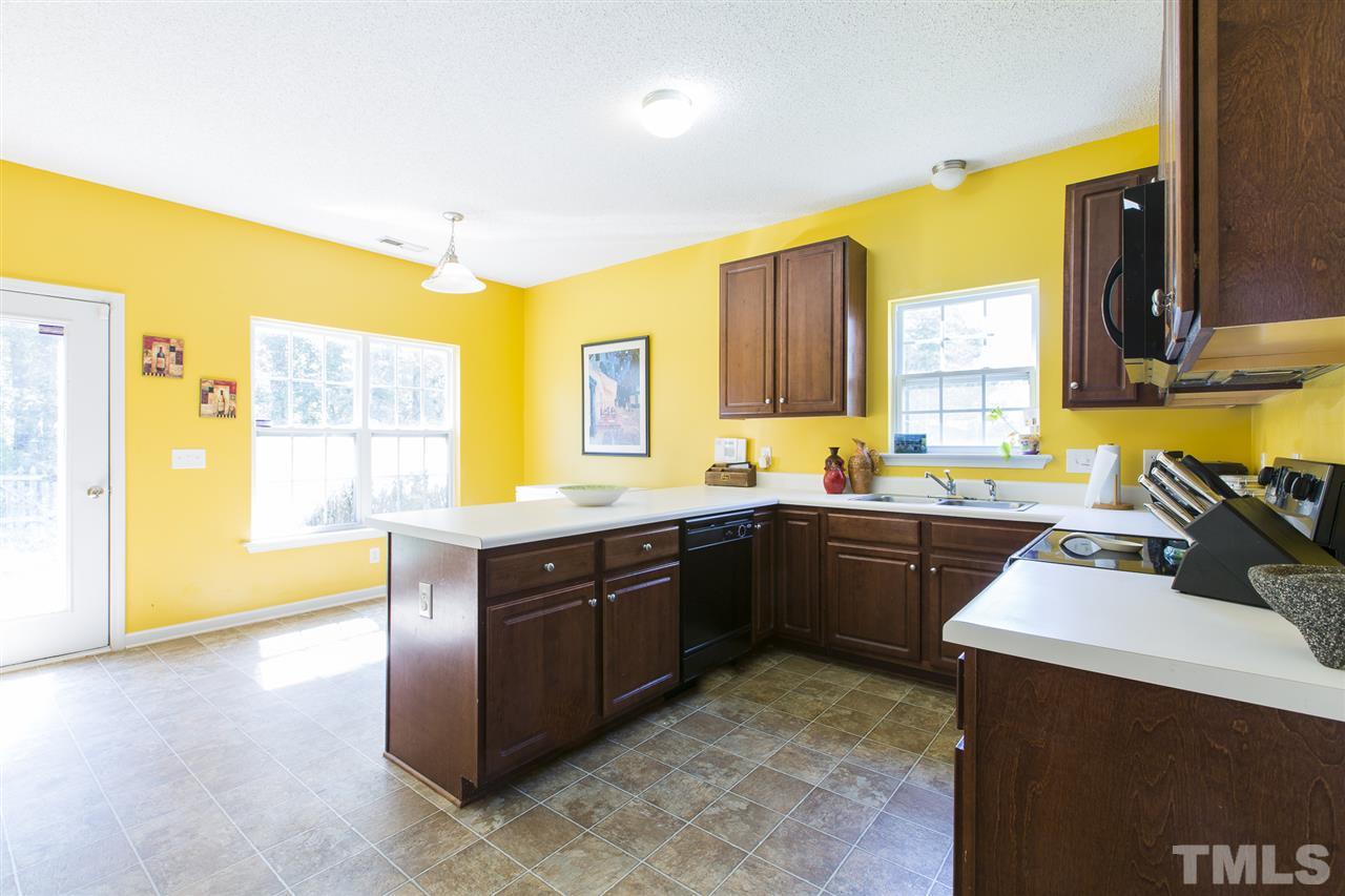 5302 Interlock Drive Raleigh, NC 27610 - Photo 8 of 19 a kitchen with a sink cabinets and wooden floor