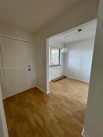 a view of a room with window and wooden floor