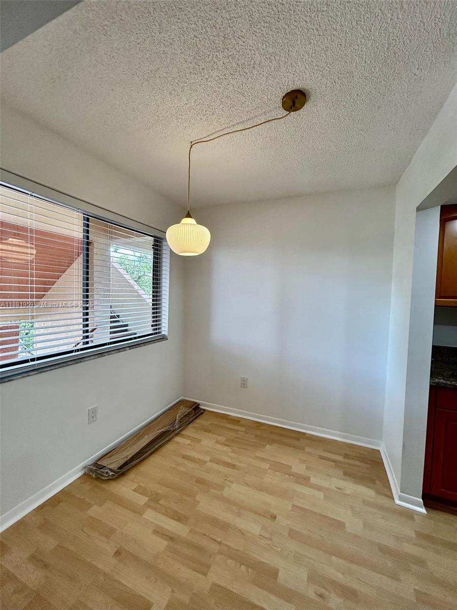 7451 Northwest 16th Street, Unit 304 Plantation, FL 33313 - Photo 15 of 59 a view of a room with window and wooden floor