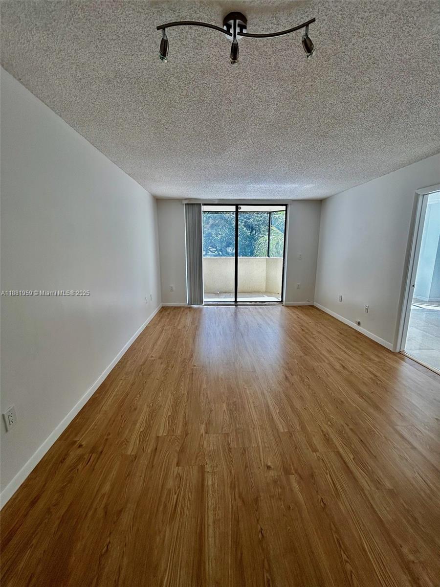 7451 Northwest 16th Street, Unit 304 Plantation, FL 33313 - Photo 16 of 59 wooden floor in an empty room with a window