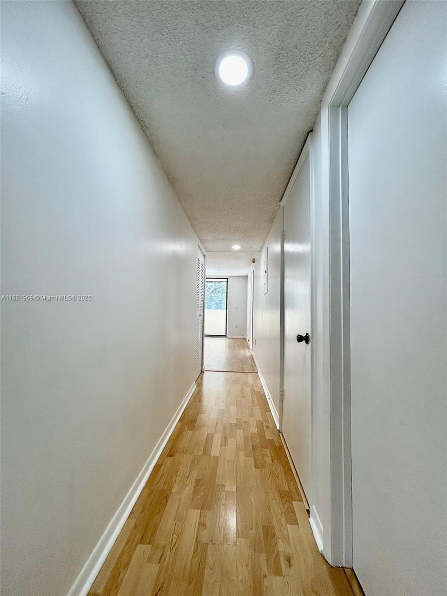 7451 Northwest 16th Street, Unit 304 Plantation, FL 33313 - Photo 21 of 59 a view of a hallway with wooden floor