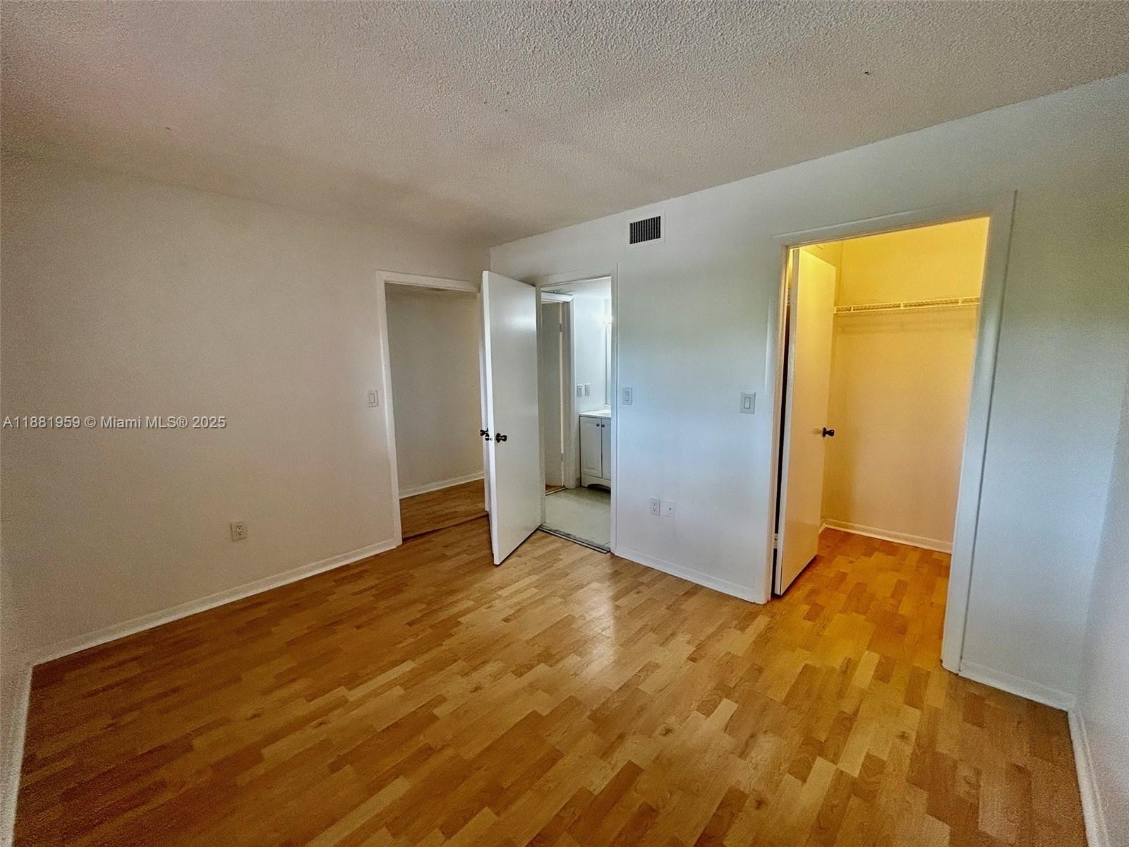 7451 Northwest 16th Street, Unit 304 Plantation, FL 33313 - Photo 33 of 59 a view of an empty room with wooden floor and a window