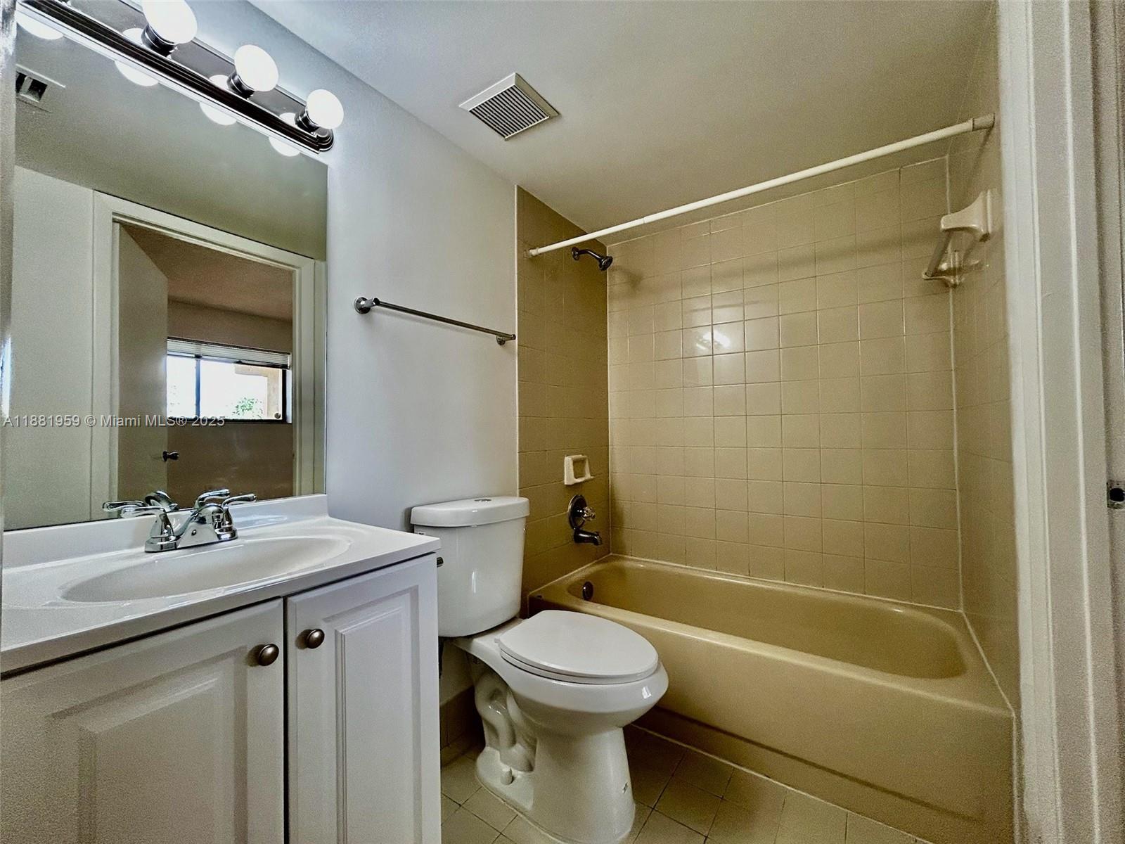 7451 Northwest 16th Street, Unit 304 Plantation, FL 33313 - Photo 34 of 59 a bathroom with a sink a toilet and shower