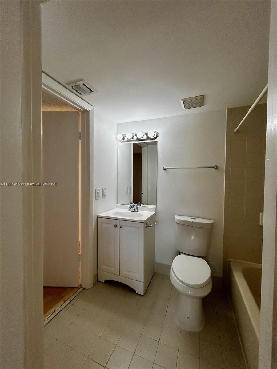7451 Northwest 16th Street, Unit 304 Plantation, FL 33313 - Photo 35 of 59 a bathroom with a granite countertop toilet sink and mirror