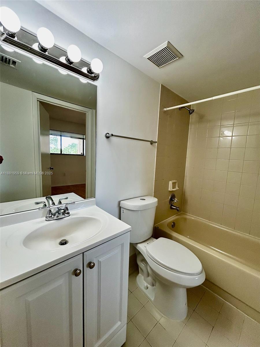 7451 Northwest 16th Street, Unit 304 Plantation, FL 33313 - Photo 36 of 59 a bathroom with a sink toilet and shower