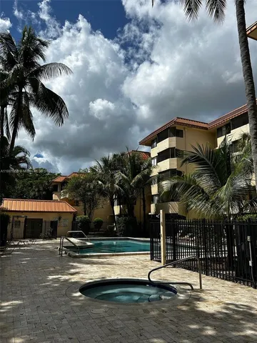 a view of a patio with table and chairs under an umbrella