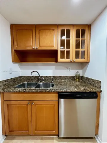 a kitchen with granite countertop cabinets and black stainless steel appliances