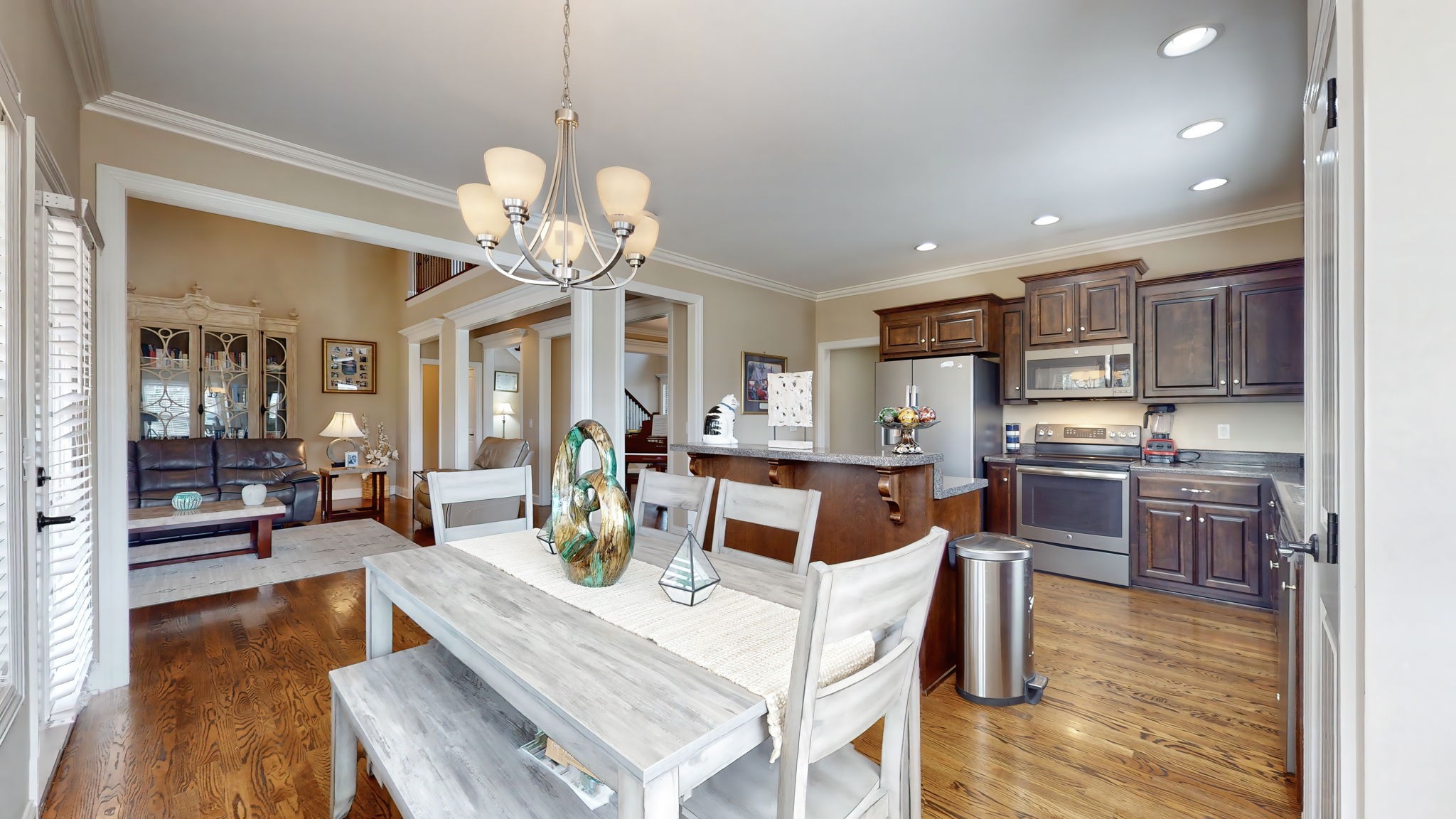 209 Hunters Ridge Drive Tullahoma, TN 37388 - Photo 14 of 54 a view of a dining room and livingroom with furniture wooden floor a chandelier