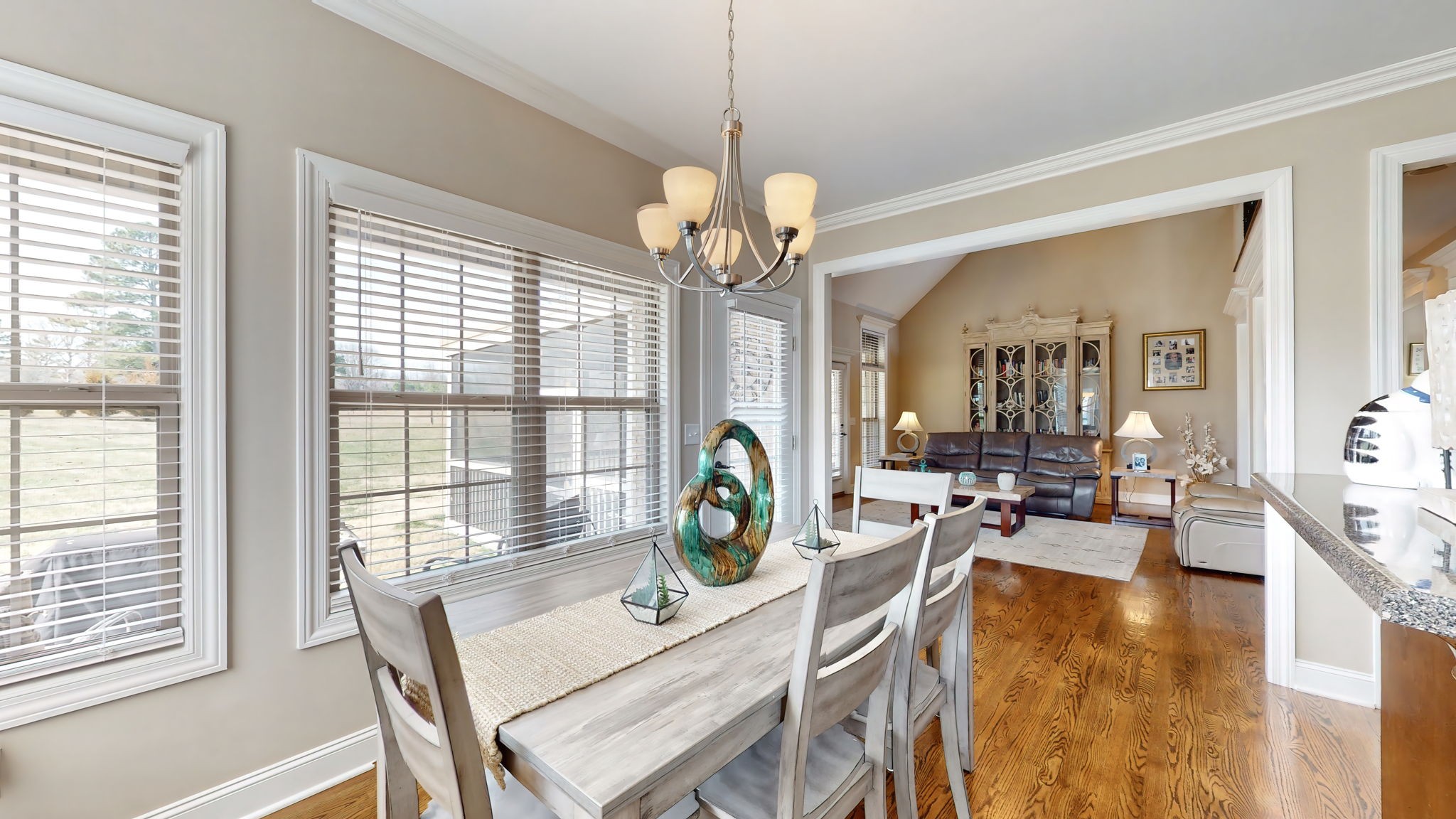 209 Hunters Ridge Drive Tullahoma, TN 37388 - Photo 15 of 54 a view of a dining room and livingroom with furniture wooden floor a chandelier