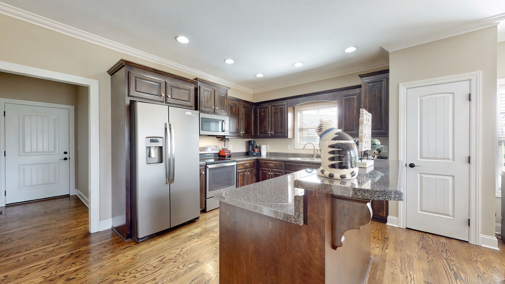209 Hunters Ridge Drive Tullahoma, TN 37388 - Photo 17 of 54 a kitchen with stainless steel appliances kitchen island granite countertop a refrigerator and a stove top oven