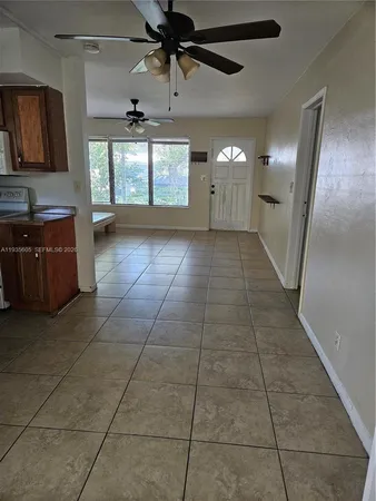 a view of a kitchen with a sink and a window