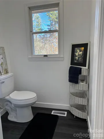 a bathroom with a toilet a sink and a window