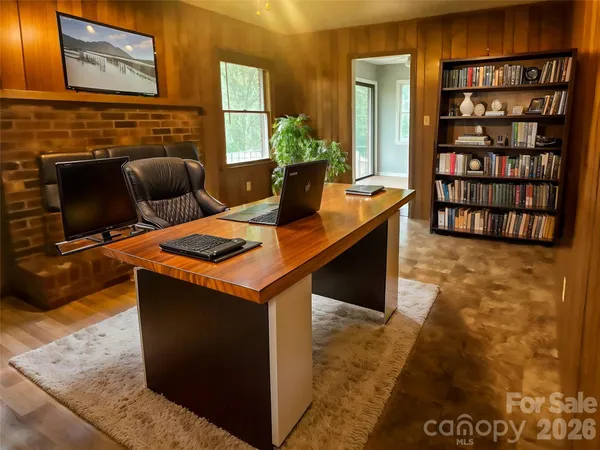 a view of kitchen island with stainless steel appliances granite countertop sink stove and wooden cabinets