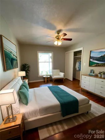 a bedroom with a bed dresser and a window