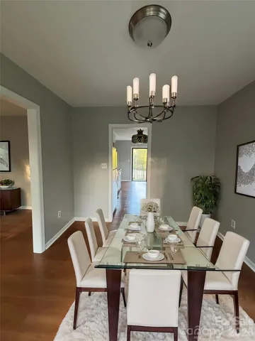 a view of a dining room with furniture and chandelier