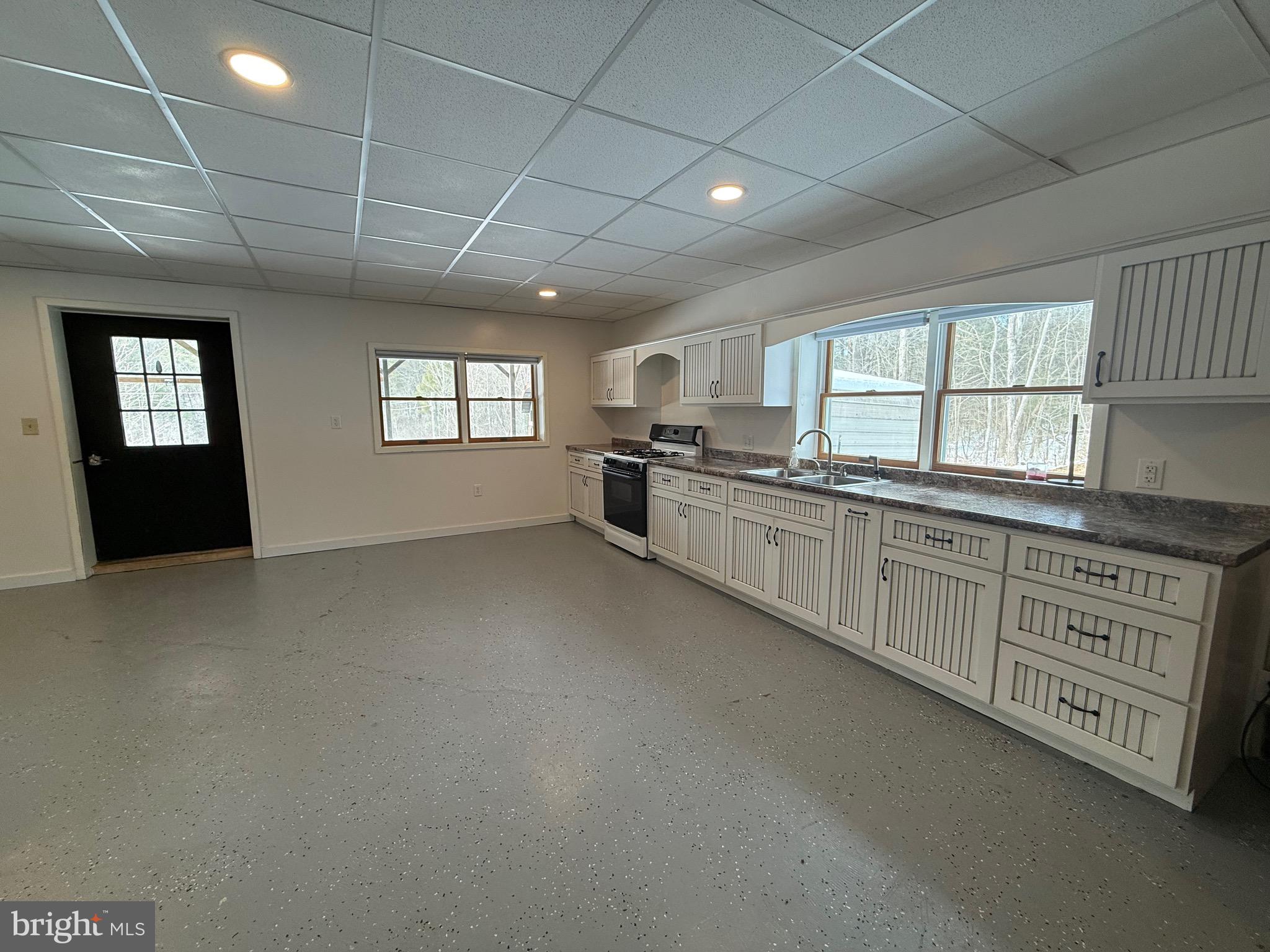 4776 Mcalevys Fort Road Petersburg, PA 16669 - Photo 69 of 75 a kitchen with stainless steel appliances granite countertop a stove a sink dishwasher and a refrigerator with wooden cabinets
