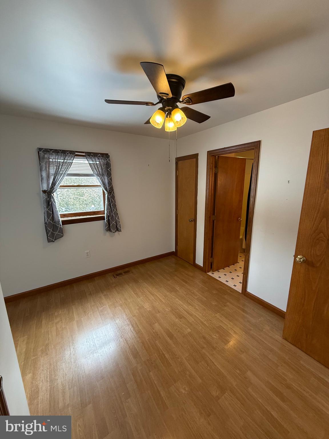 4776 Mcalevys Fort Road Petersburg, PA 16669 - Photo 9 of 75 a view of empty room with wooden floor and fan