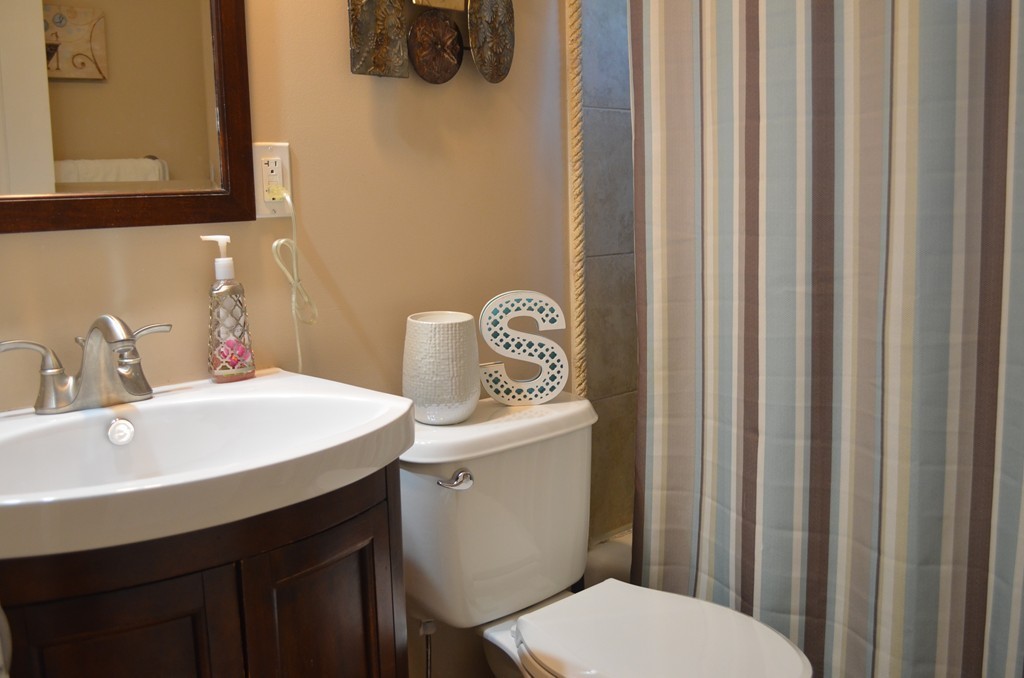 111 Acropolis Road Lowell, MA 01854 - Photo 11 of 15 a bathroom with a sink a toilet and a mirror