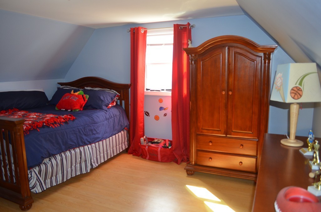 111 Acropolis Road Lowell, MA 01854 - Photo 12 of 15 a bedroom with a bed and a window
