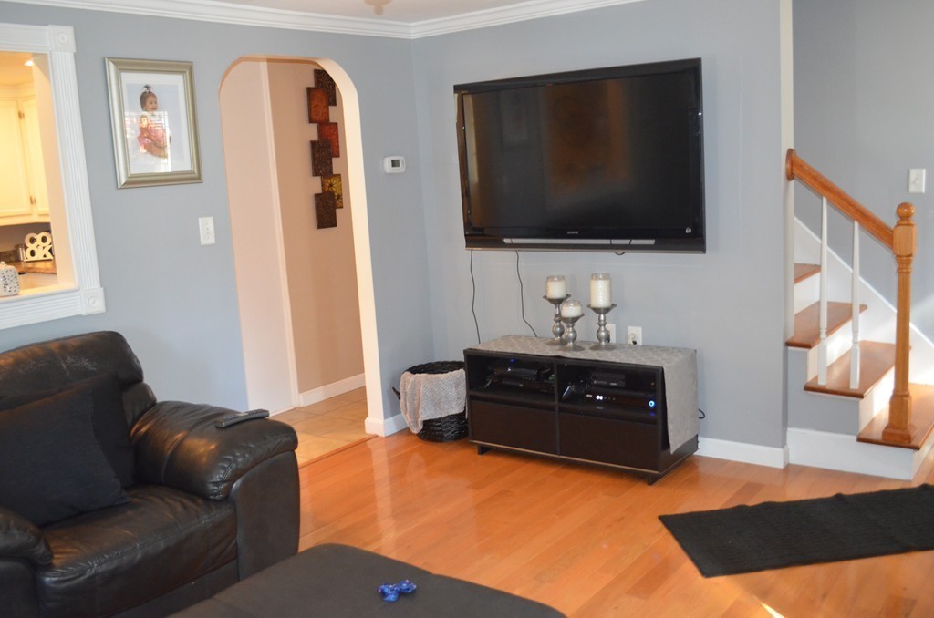 111 Acropolis Road Lowell, MA 01854 - Photo 8 of 15 a living room with furniture and a flat screen tv
