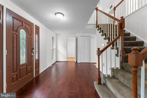 a view of entryway with wooden floor and stairs