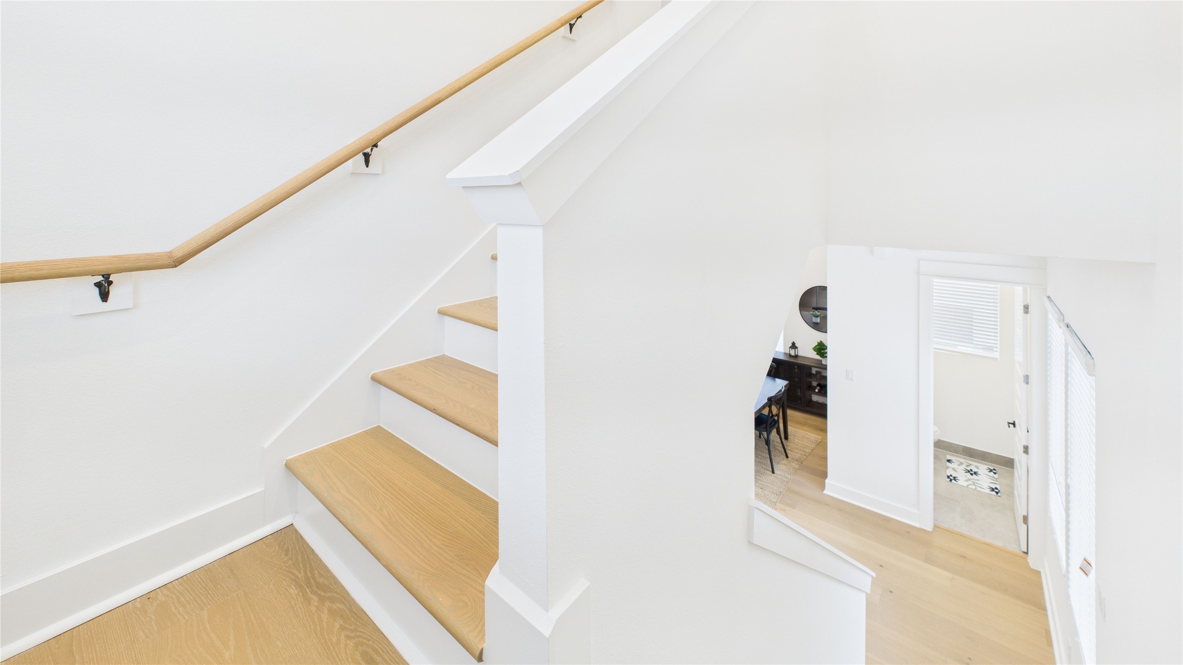 2426 Freeman Street Houston, TX 77009 - Photo 25 of 47 The staircase connecting the second and third floors features a clean design, providing a seamless transition between levels while complementing the home’s style.