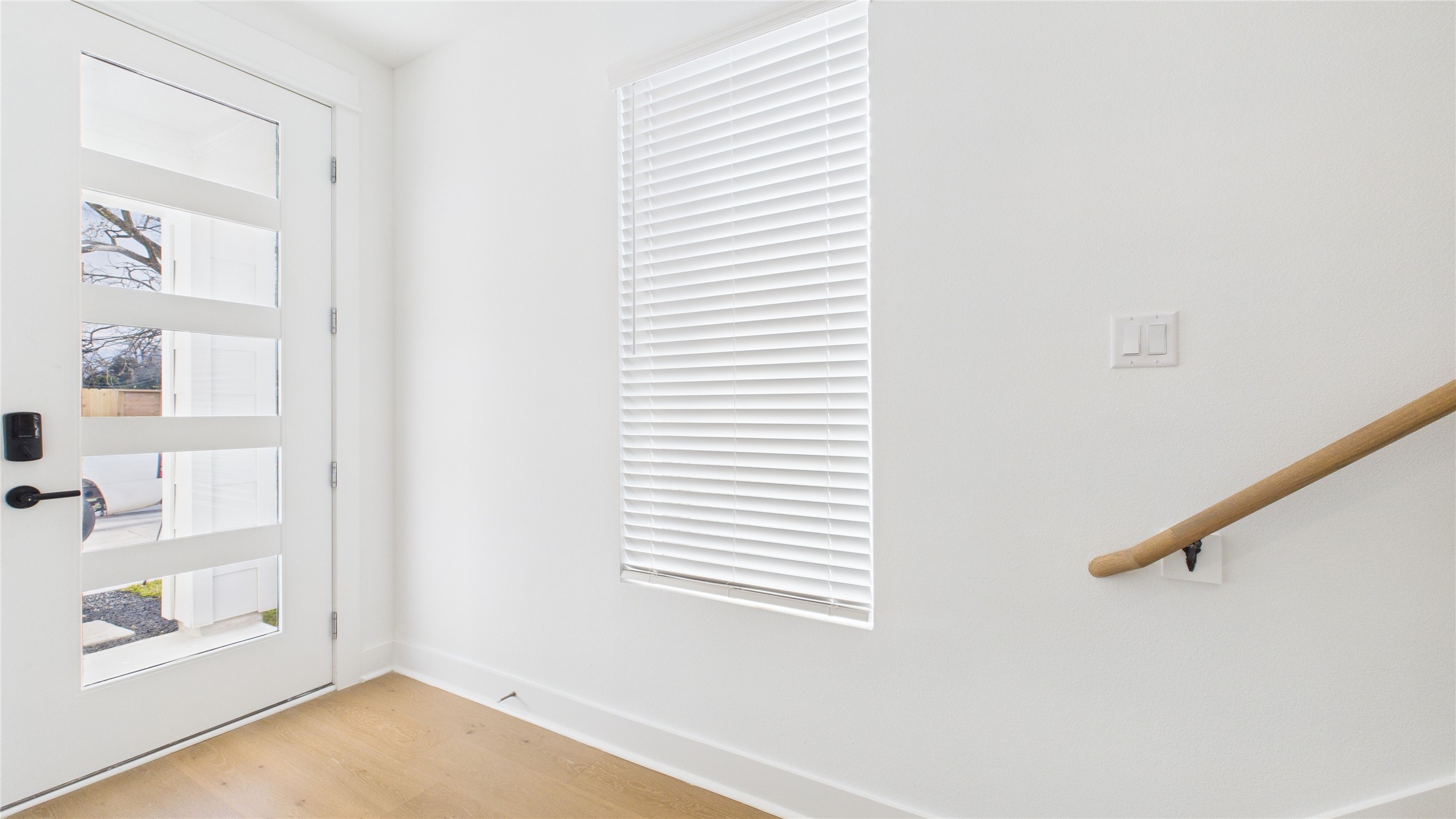 2426 Freeman Street Houston, TX 77009 - Photo 5 of 47 The welcoming foyer, located just off the front door, provides convenient access to the secondary bedroom and the garage, creating a functional and well-organized entry that sets the tone for the home’s thoughtful layout.